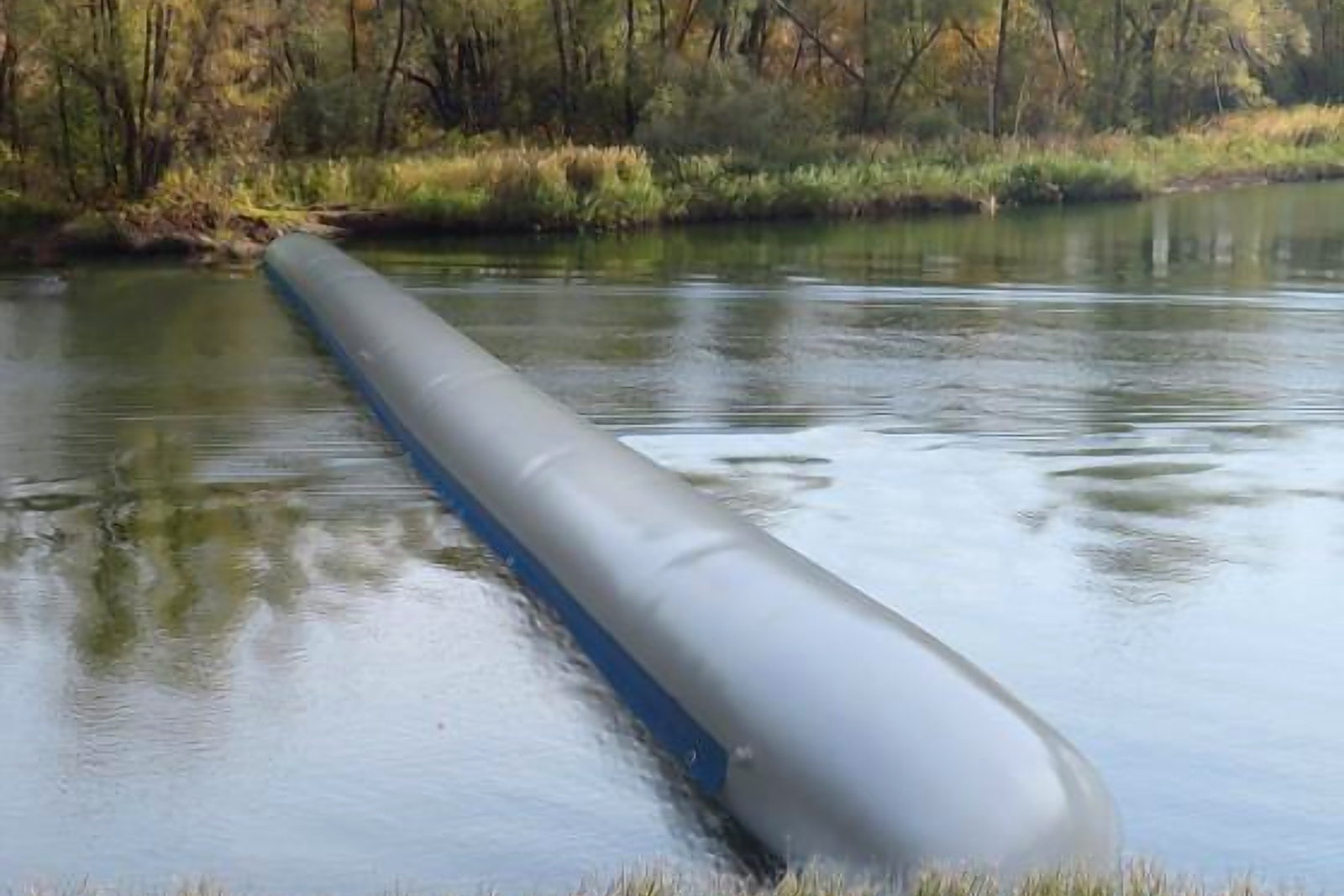 A water-filled dam laid across a watercourse, inflated to hold the upstream level